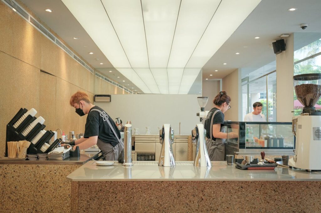 A coffee shop with people working at the counter